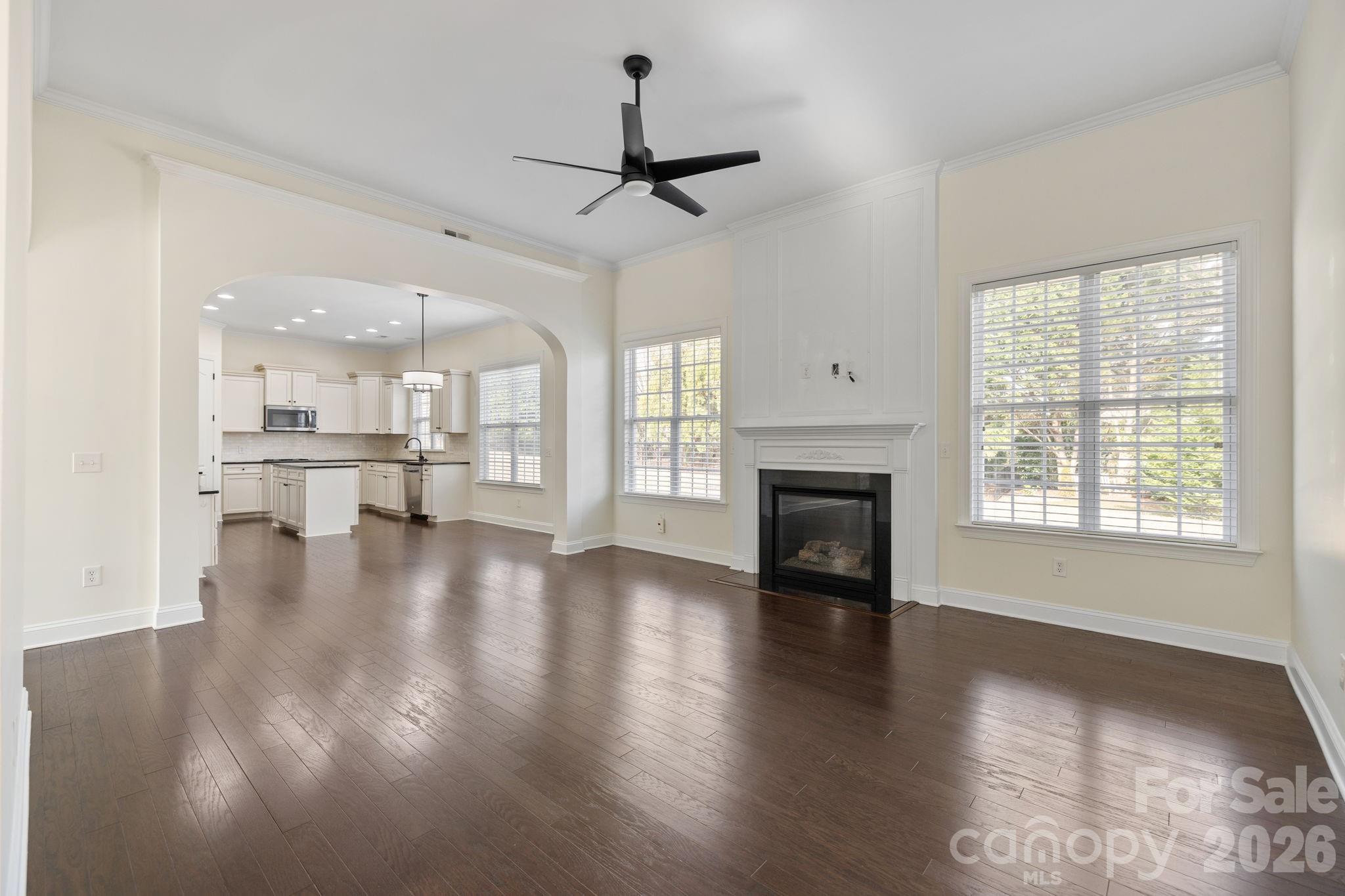 646 Quicksilver Trail Fort Mill, SC 29708 - Photo 11 of 48 a view of a livingroom with a fireplace a ceiling fan and windows