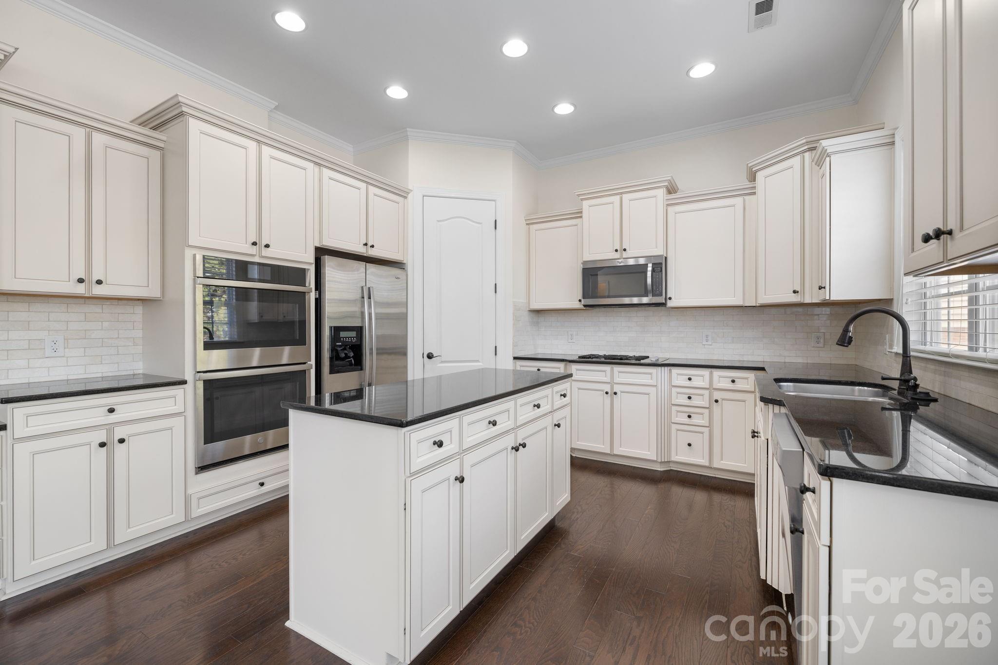 646 Quicksilver Trail Fort Mill, SC 29708 - Photo 17 of 48 a kitchen with granite countertop white cabinets and stainless steel appliances