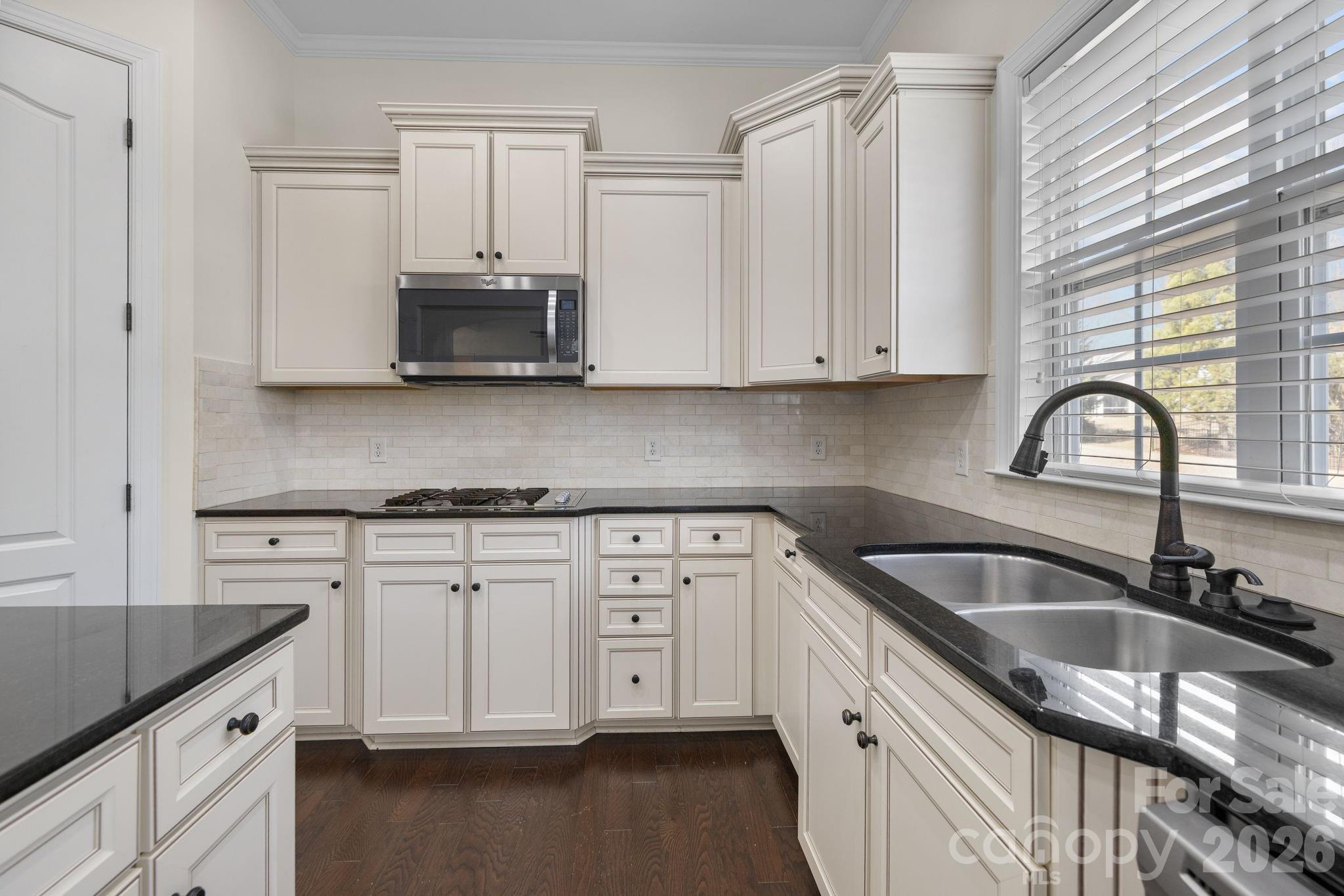 646 Quicksilver Trail Fort Mill, SC 29708 - Photo 18 of 48 a kitchen with granite countertop a sink stove and cabinets