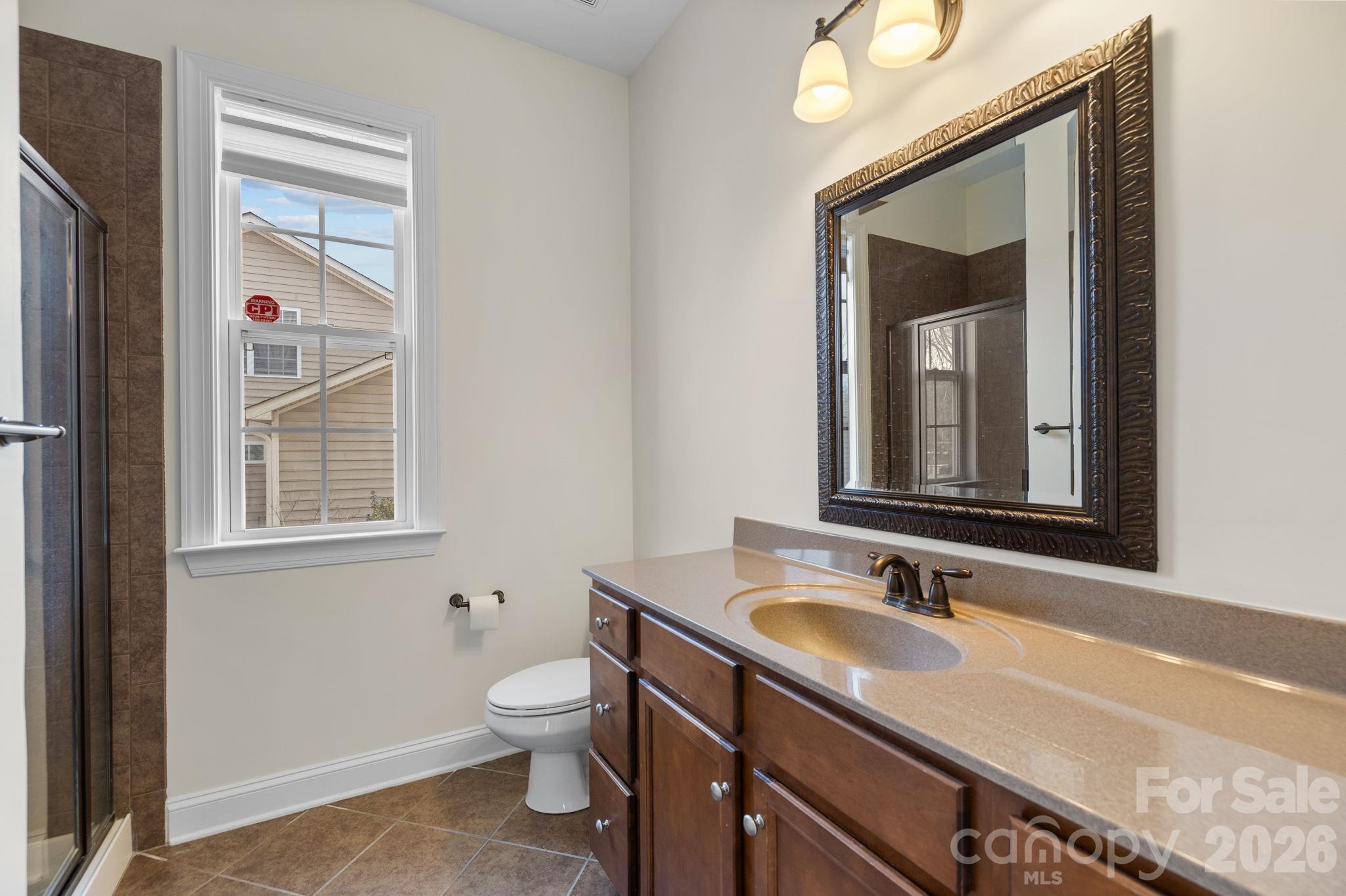 646 Quicksilver Trail Fort Mill, SC 29708 - Photo 23 of 48 a bathroom with a sink a toilet and a mirror