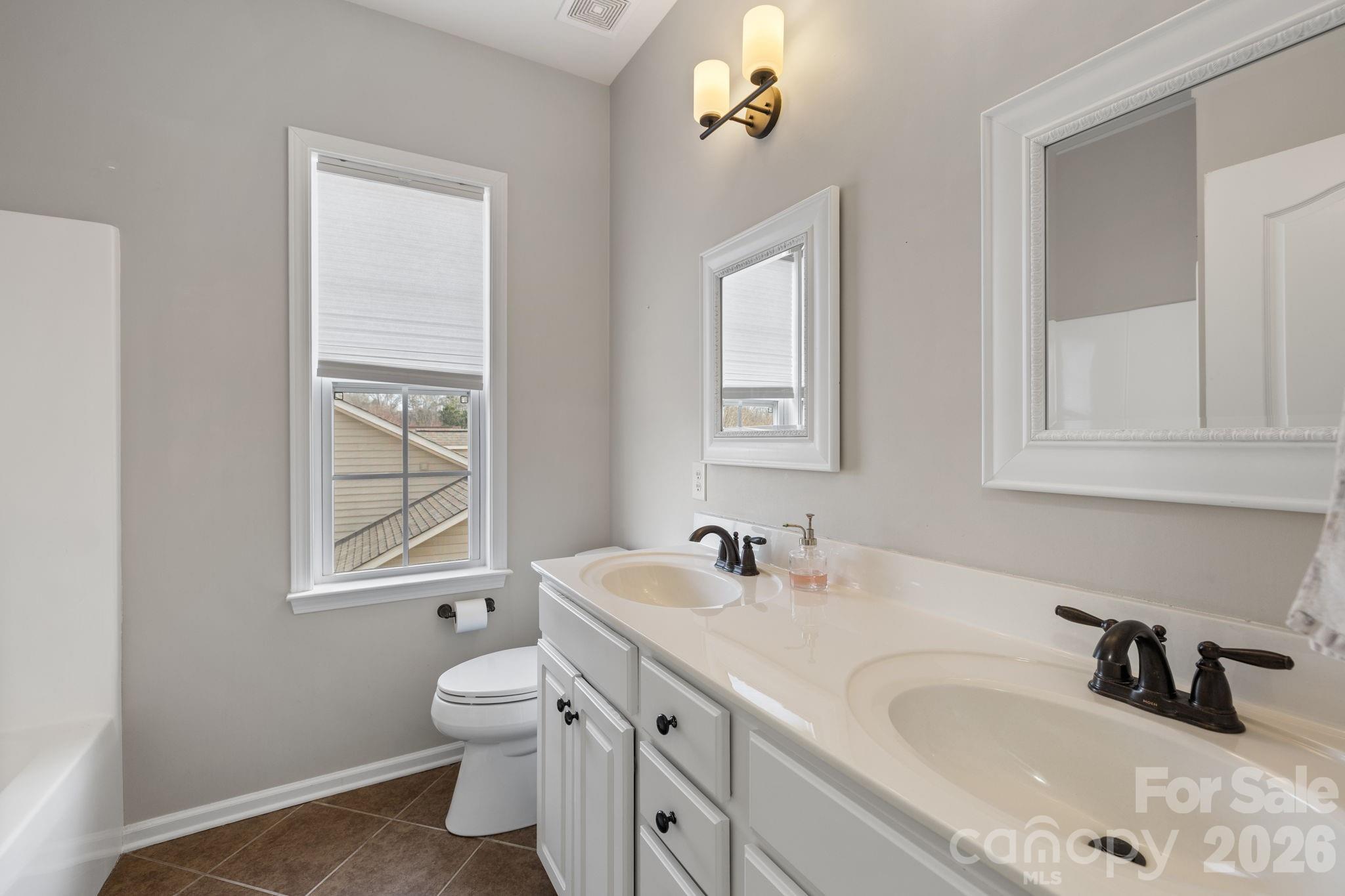 646 Quicksilver Trail Fort Mill, SC 29708 - Photo 27 of 48 a bathroom with a sink double vanity and a toilet