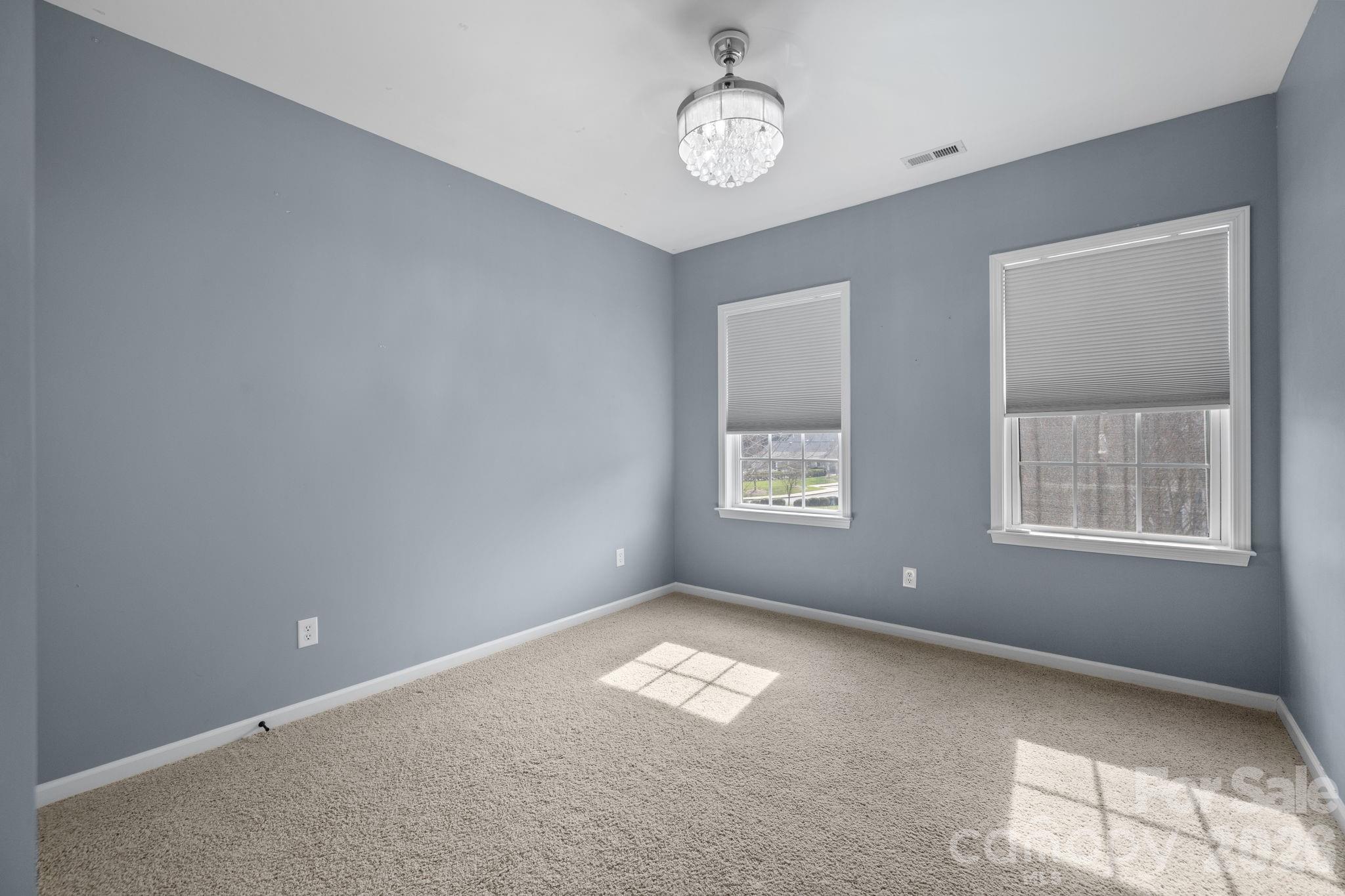 646 Quicksilver Trail Fort Mill, SC 29708 - Photo 29 of 48 en empty room with windows and ceiling fan