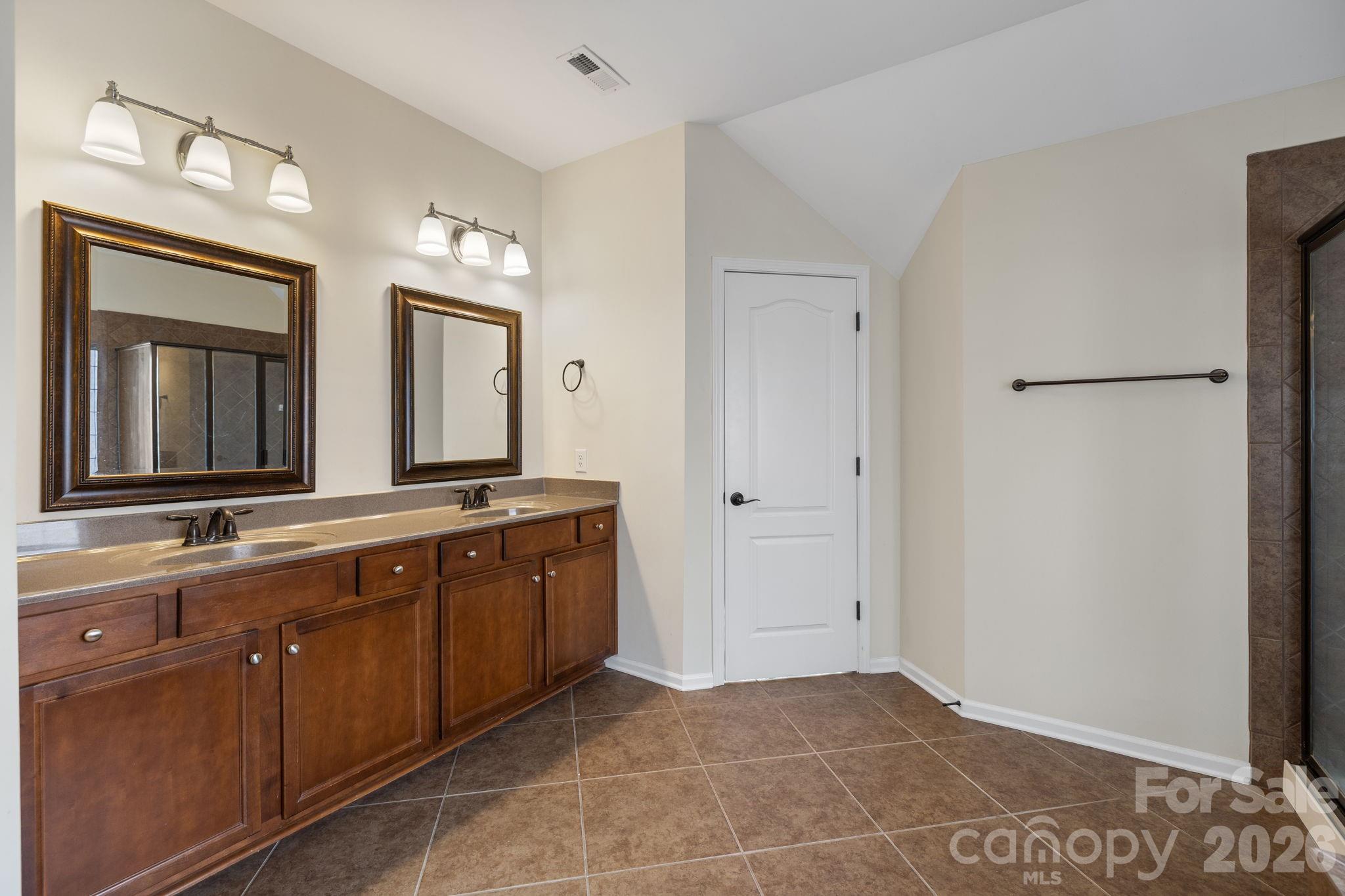 646 Quicksilver Trail Fort Mill, SC 29708 - Photo 37 of 48 a spacious bathroom with a double vanity sink and a mirror