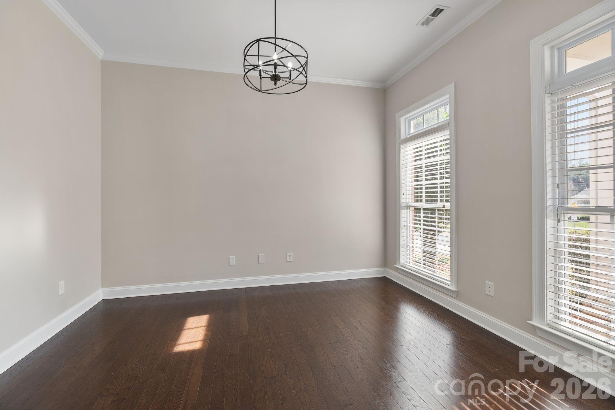 646 Quicksilver Trail Fort Mill, SC 29708 - Photo 5 of 48 an empty room with wooden floor and windows