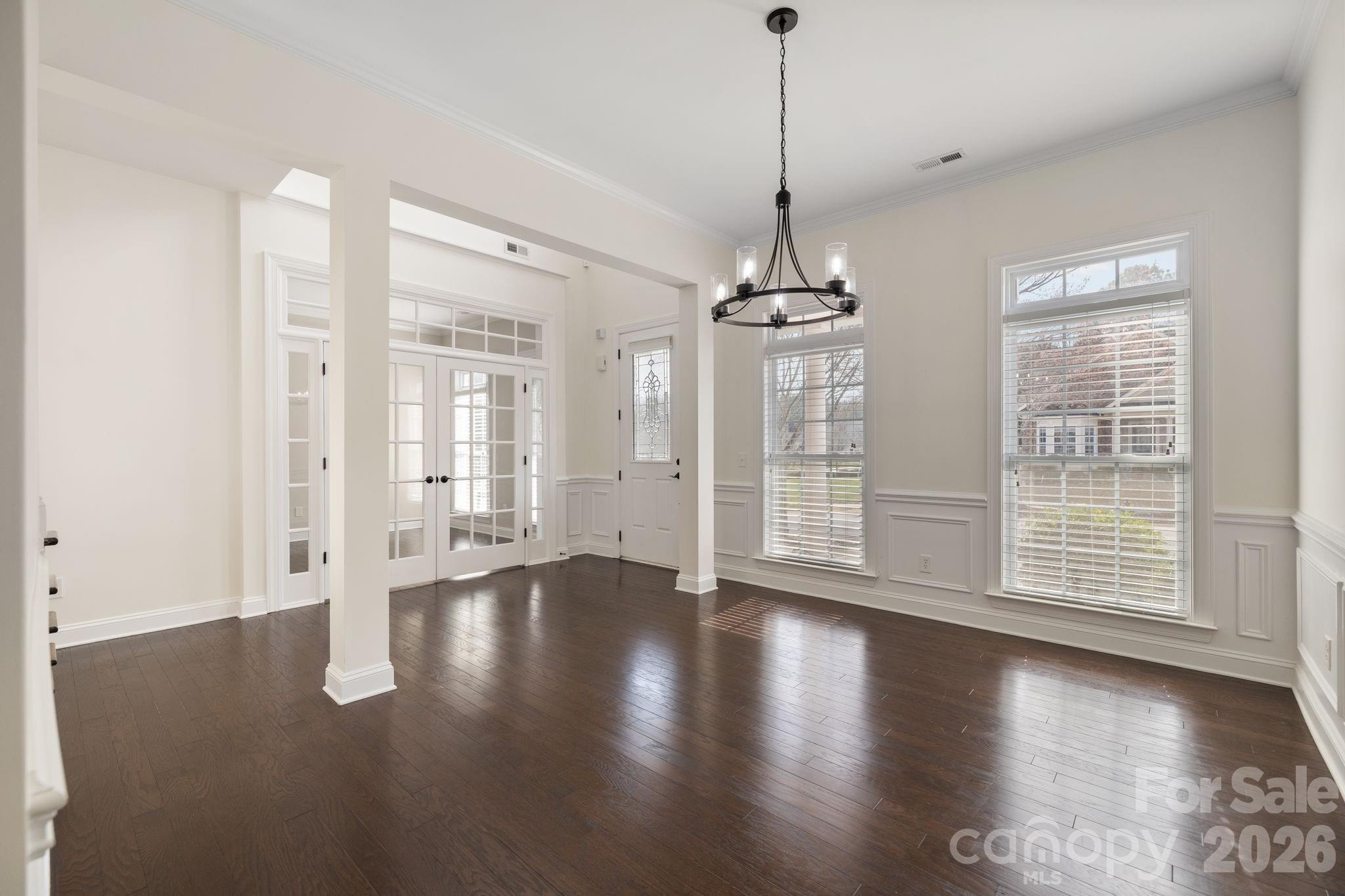 646 Quicksilver Trail Fort Mill, SC 29708 - Photo 8 of 48 a view of an empty room with wooden floor and a window