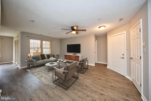 a living room with furniture fireplace and a flat screen tv