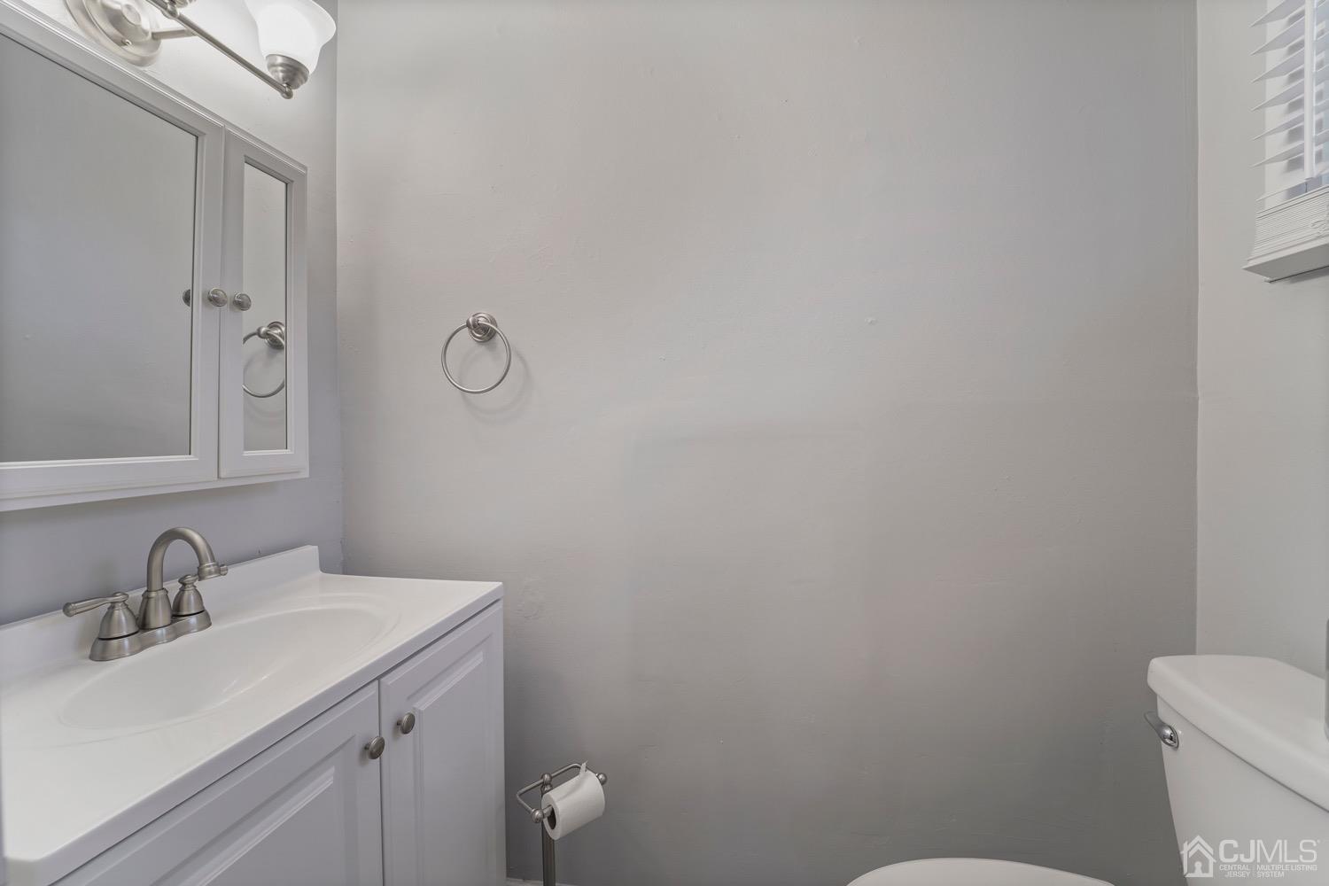 12 Fordham Road Old Bridge, NJ 08859 - Photo 19 of 32 a bathroom with a sink a toilet and a mirror