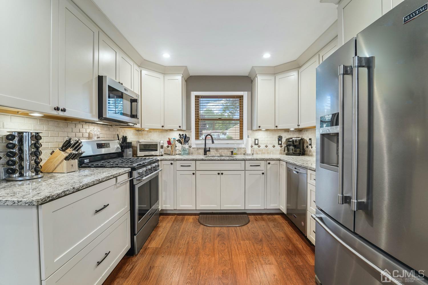 12 Fordham Road Old Bridge, NJ 08859 - Photo 5 of 32 a kitchen with a sink window and cabinets