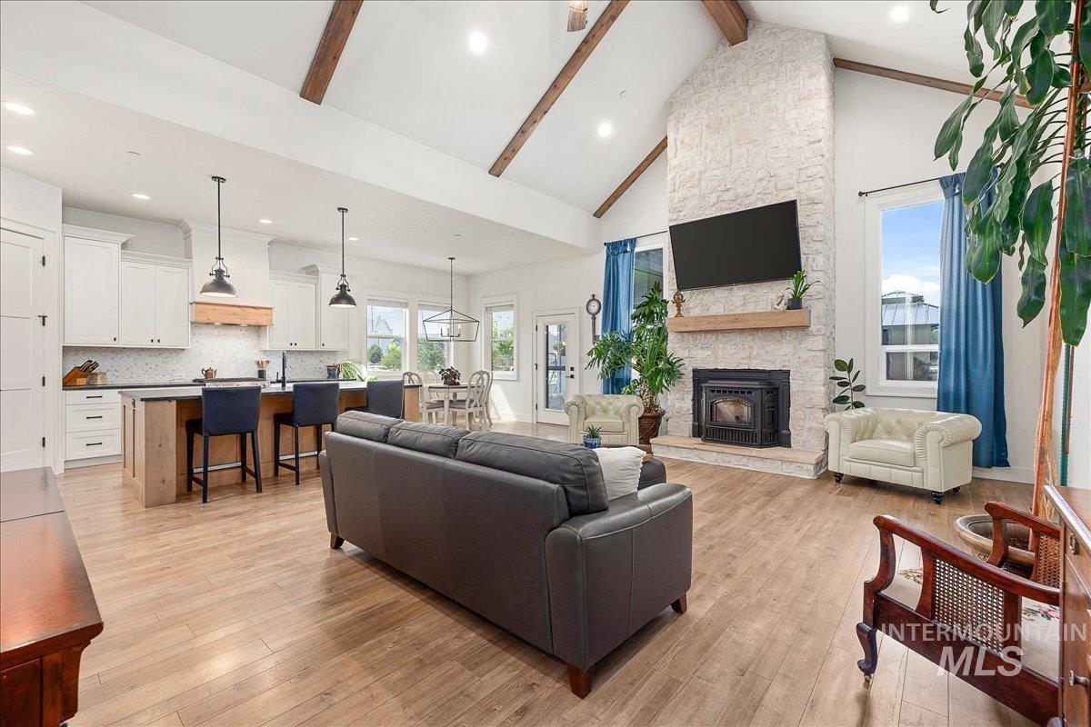 24301 Wanda Way Middleton, ID 83644 - Photo 4 of 50 Living area with beamed ceiling, high vaulted ceiling, recessed lighting, light wood finished floors, and a fireplace