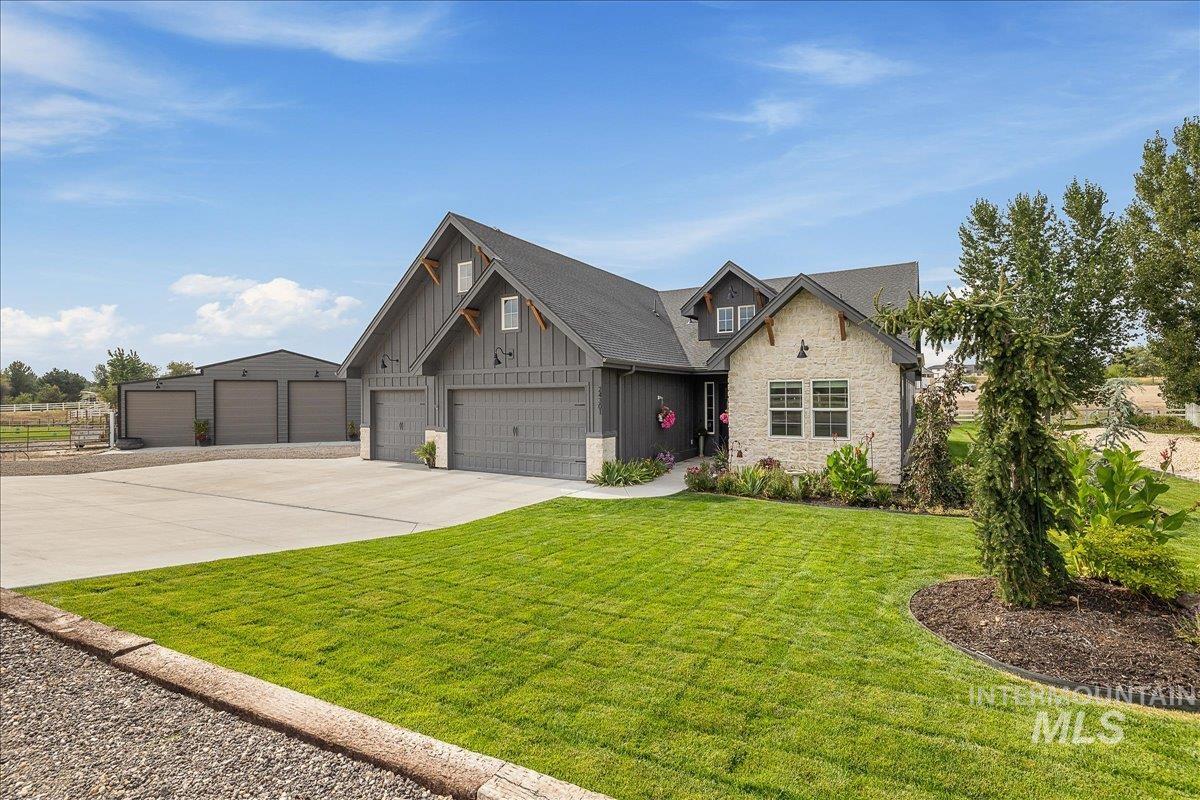 24301 Wanda Way Middleton, ID 83644 - Photo 43 of 50 Craftsman inspired home featuring stone siding, driveway, board and batten siding, and a front lawn