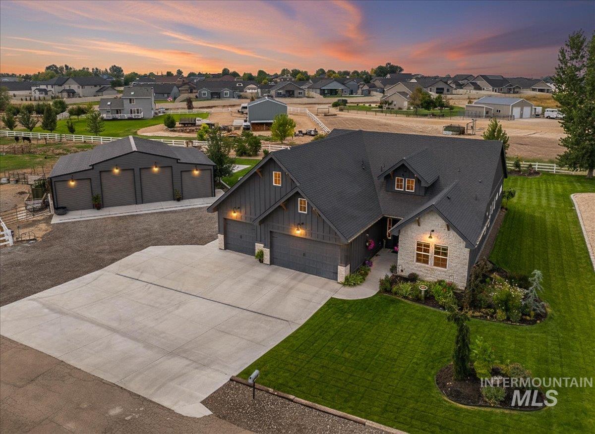 24301 Wanda Way Middleton, ID 83644 - Photo 46 of 50 View of front of house with stone siding, concrete driveway, board and batten siding, and a residential view