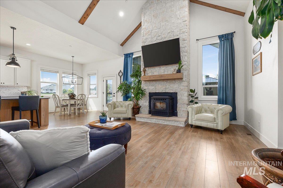 24301 Wanda Way Middleton, ID 83644 - Photo 9 of 50 Living area featuring wood finished floors, high vaulted ceiling, recessed lighting, and a fireplace