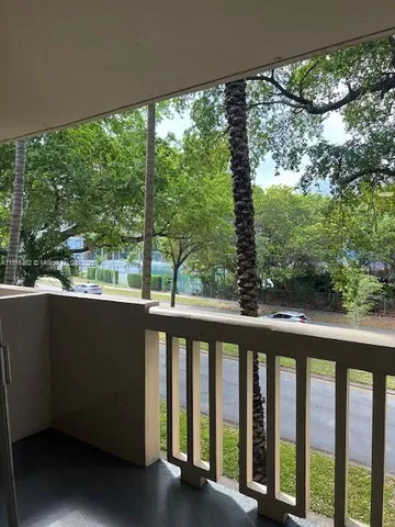a view of a balcony with wooden floor