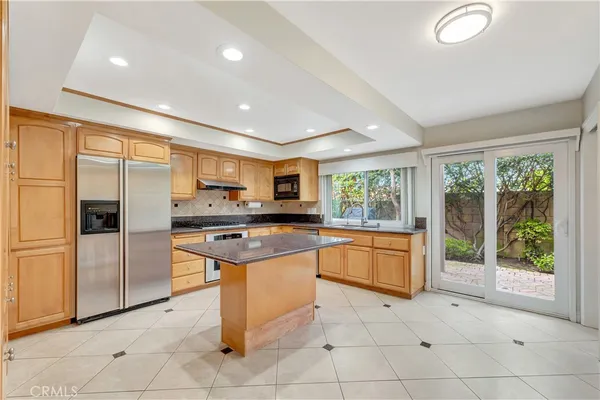 a kitchen with granite countertop a sink and cabinets