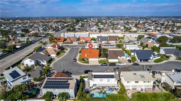 a aerial view of a house with swimming pool and outdoor seating