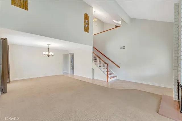 a kitchen with granite countertop a sink and white cabinets