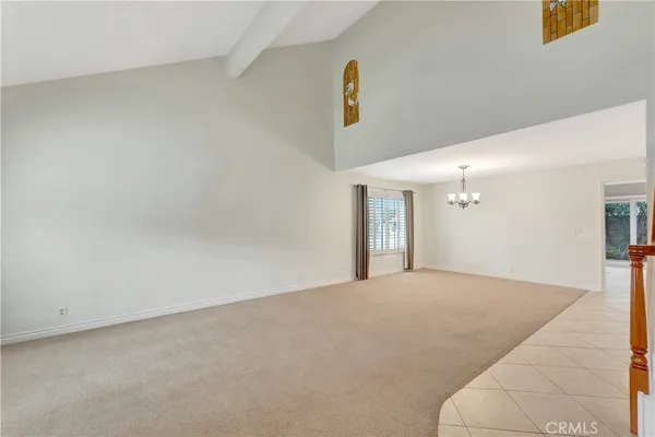 a kitchen with granite countertop a sink and white cabinets