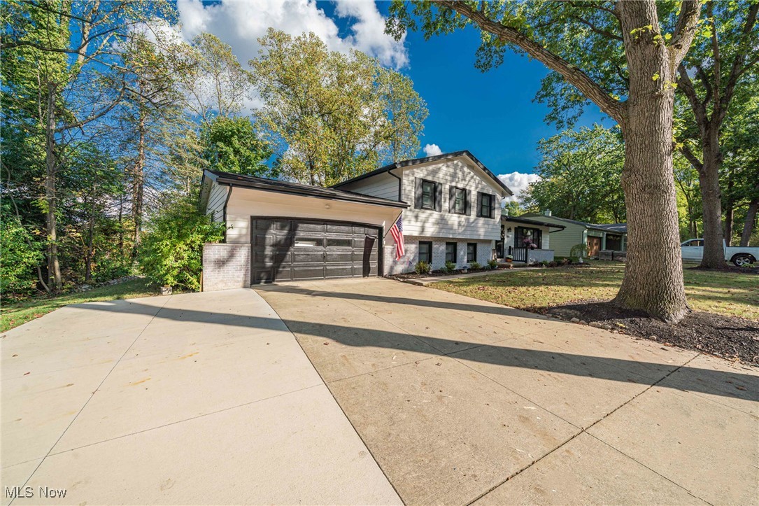 595 Moorfield Road Fairlawn, OH 44313 - Photo 2 of 50 Tri-level home with concrete driveway, brick siding, and an attached garage