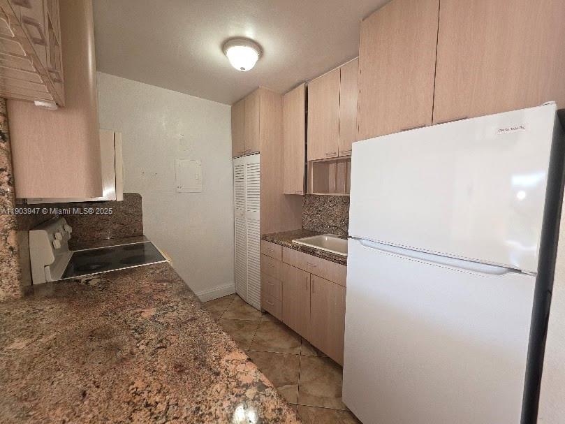 5505 Northwest 7th Street, Unit W401 Miami, FL 33126 - Photo 4 of 11 a white refrigerator freezer sitting inside of a kitchen