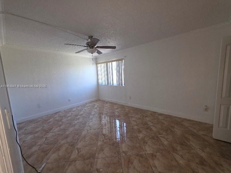 5505 Northwest 7th Street, Unit W401 Miami, FL 33126 - Photo 9 of 11 en empty room with windows and chandelier fan