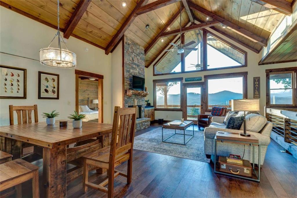 370 High Ridge Road Epworth, GA 30541 - Photo 13 of 42 a living room with furniture a chandelier and a dining table with wooden floor