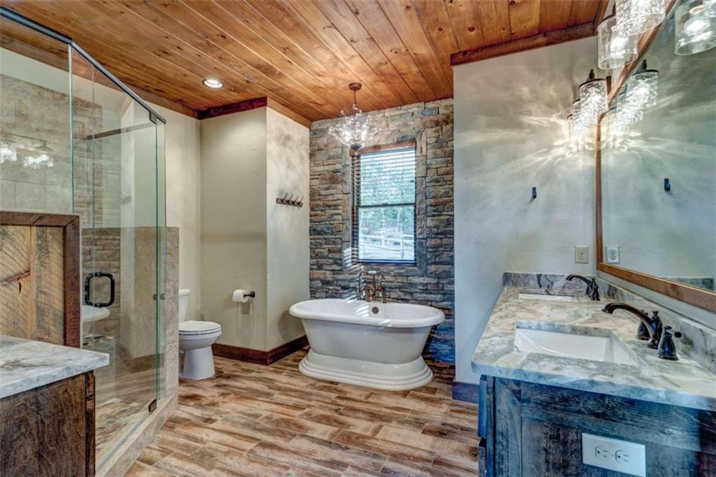 370 High Ridge Road Epworth, GA 30541 - Photo 17 of 42 a bathroom with a granite countertop sink a toilet and shower