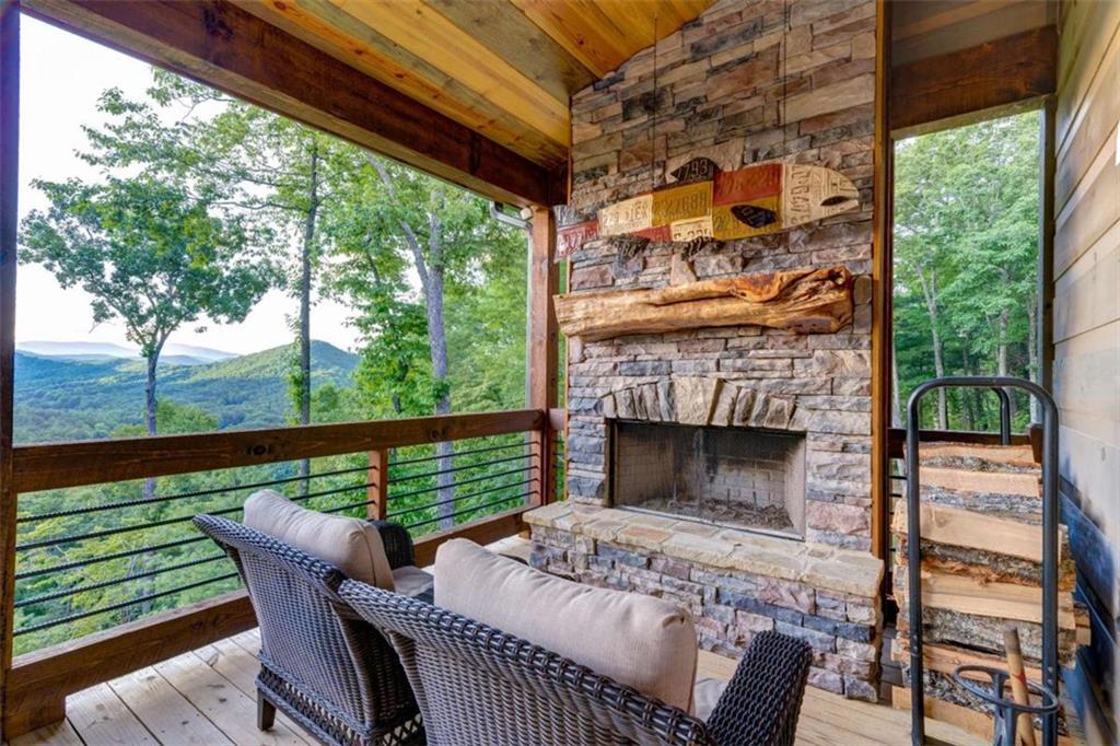 370 High Ridge Road Epworth, GA 30541 - Photo 18 of 42 a outdoor living space with a fireplace and a floor to ceiling window