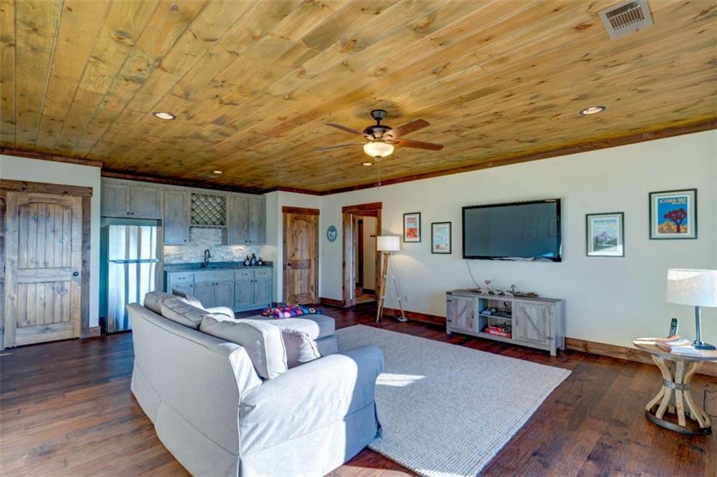 370 High Ridge Road Epworth, GA 30541 - Photo 21 of 42 a living room with furniture and a flat screen tv