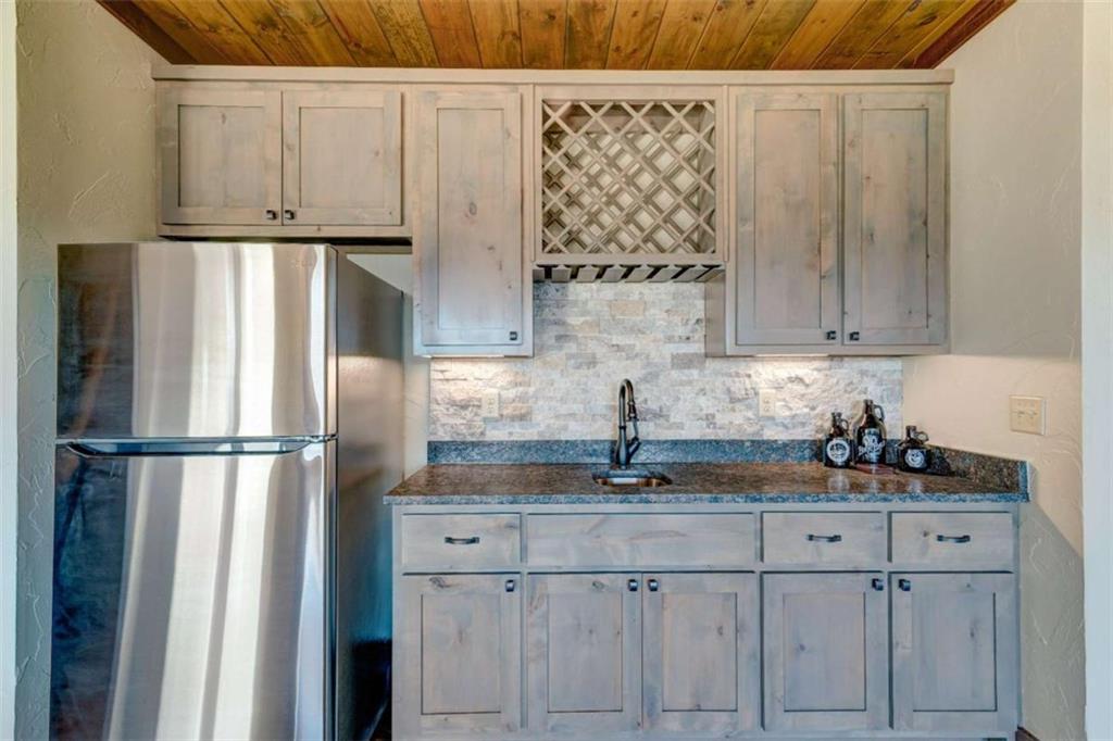 370 High Ridge Road Epworth, GA 30541 - Photo 24 of 42 a kitchen with stainless steel appliances granite countertop a refrigerator sink and white cabinets