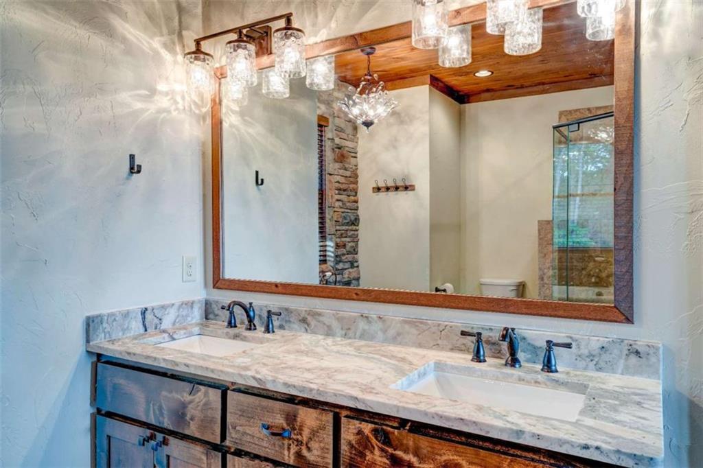 370 High Ridge Road Epworth, GA 30541 - Photo 27 of 42 a bathroom with a granite countertop sink and a mirror