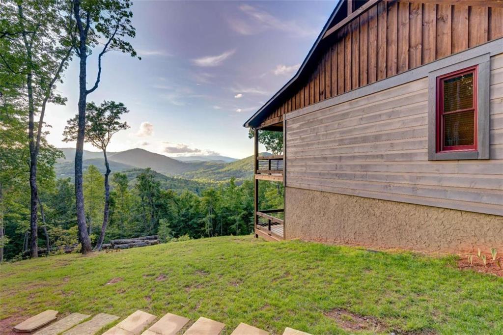 370 High Ridge Road Epworth, GA 30541 - Photo 37 of 42 a backyard of a house with large trees and plants