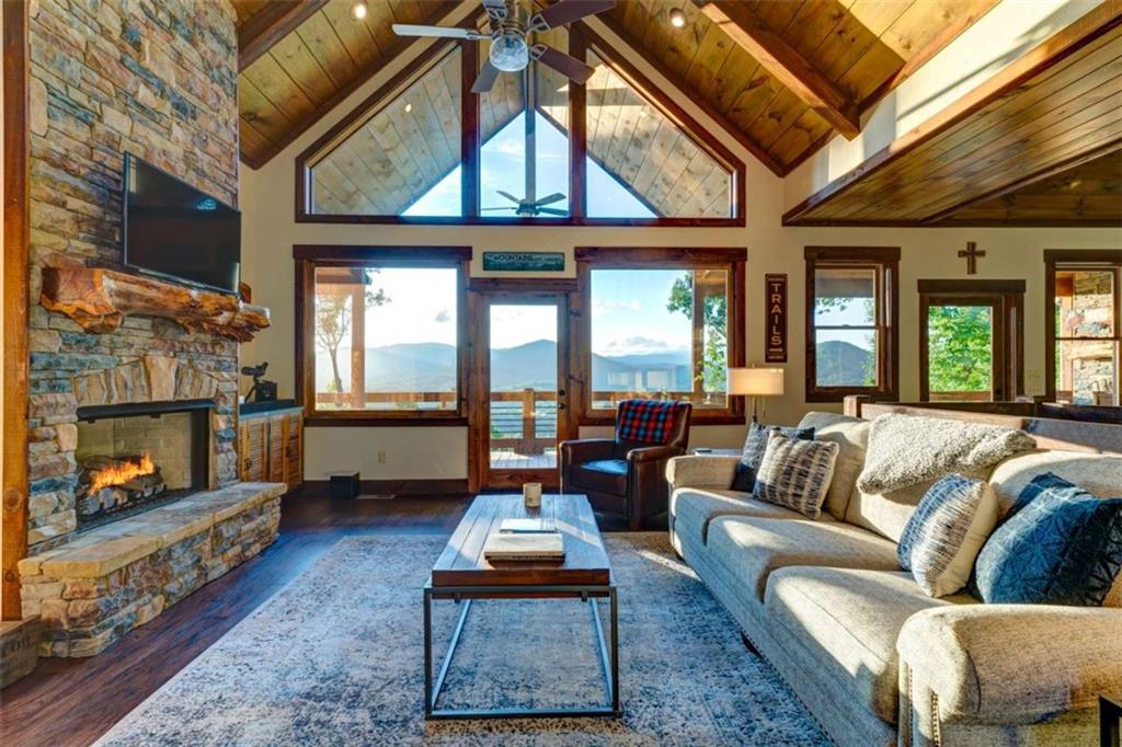 370 High Ridge Road Epworth, GA 30541 - Photo 41 of 42 a living room with furniture a fireplace and a floor to ceiling window