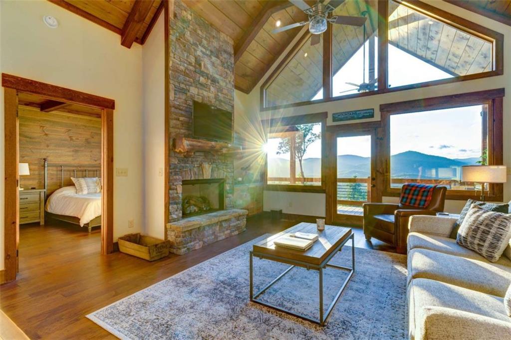 370 High Ridge Road Epworth, GA 30541 - Photo 42 of 42 a living room with furniture a rug and a floor to ceiling window