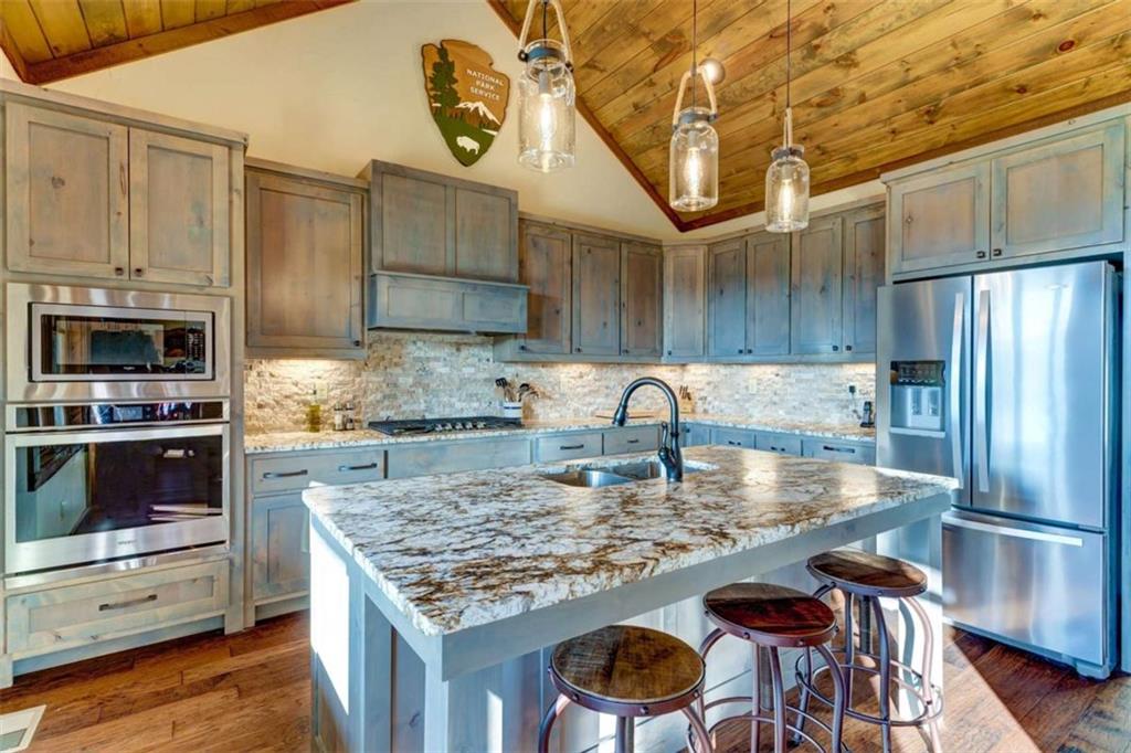 370 High Ridge Road Epworth, GA 30541 - Photo 9 of 42 a kitchen with kitchen island granite countertop a stove and a refrigerator