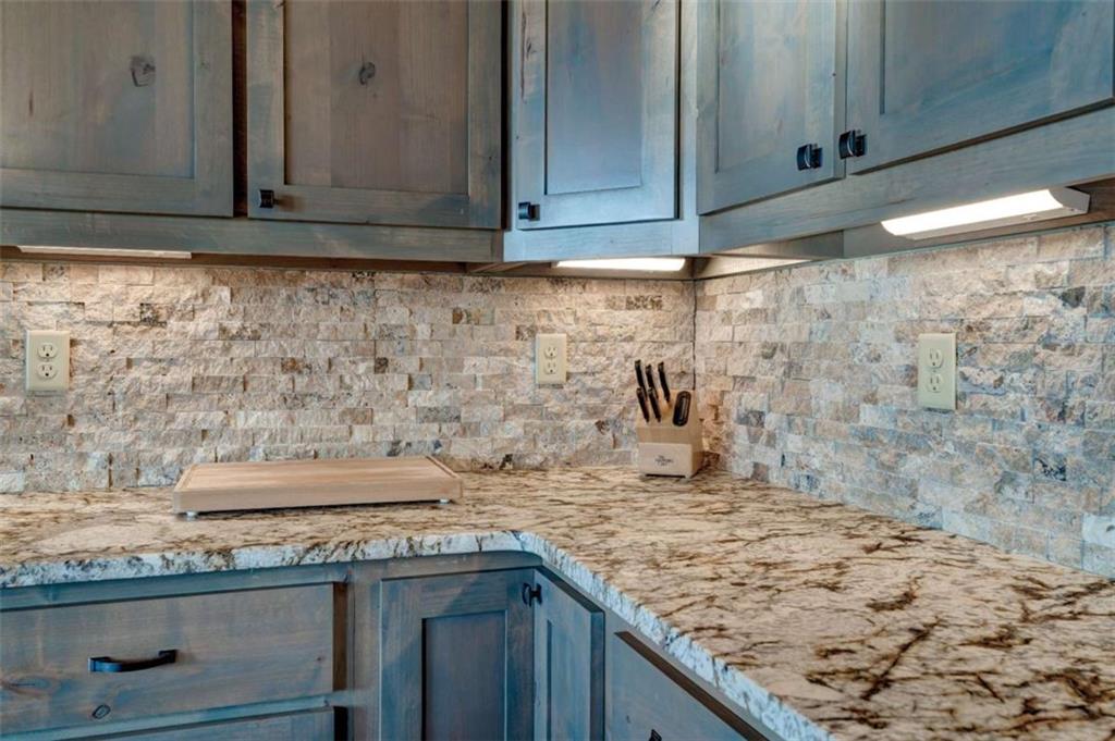 370 High Ridge Road Epworth, GA 30541 - Photo 10 of 42 a kitchen with granite countertop sink and cabinets