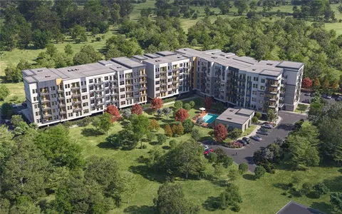 a view of a building the street and trees