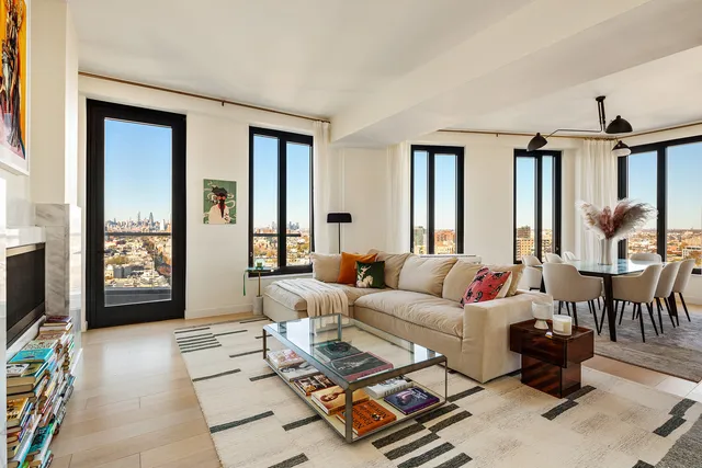 a living room with furniture a flat screen tv and a floor to ceiling window