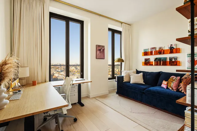 a bedroom with a bed and a large window