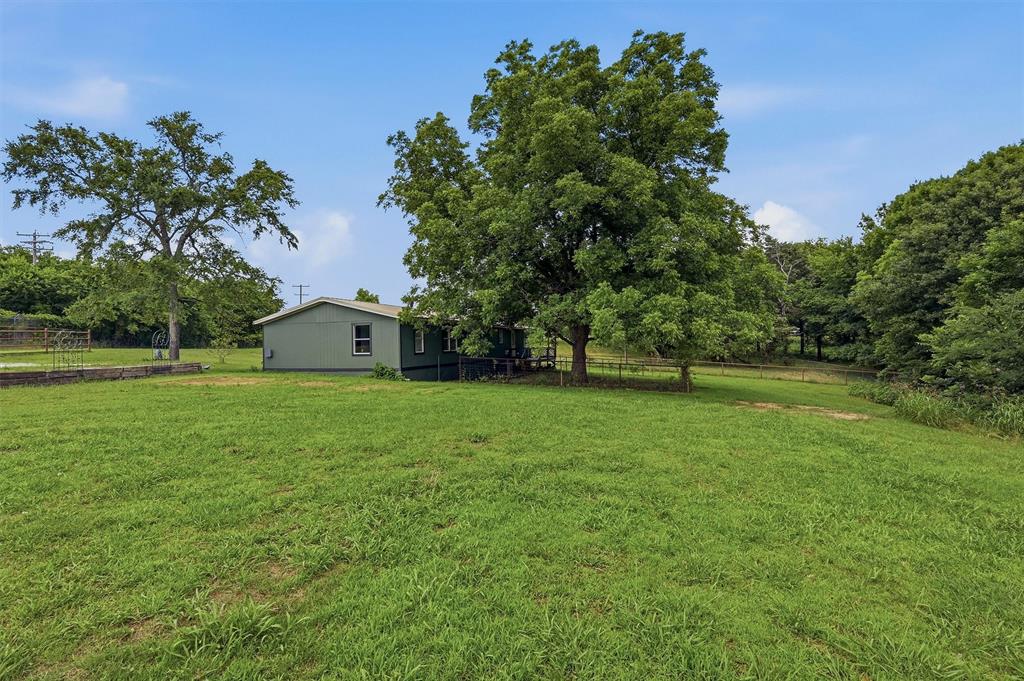 150 Gilbreath Road Sadler, TX 76264 - Photo 29 of 34 a front view of a house with garden