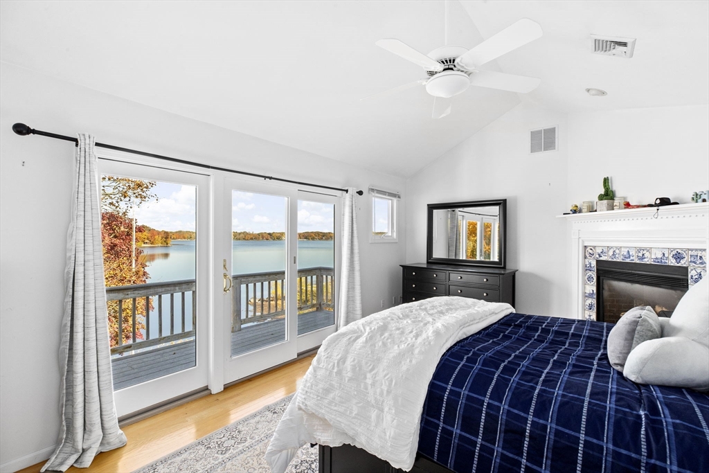 22 Beach Road Sharon, MA 02067 - Photo 13 of 27 a bedroom with a large bed and a fireplace