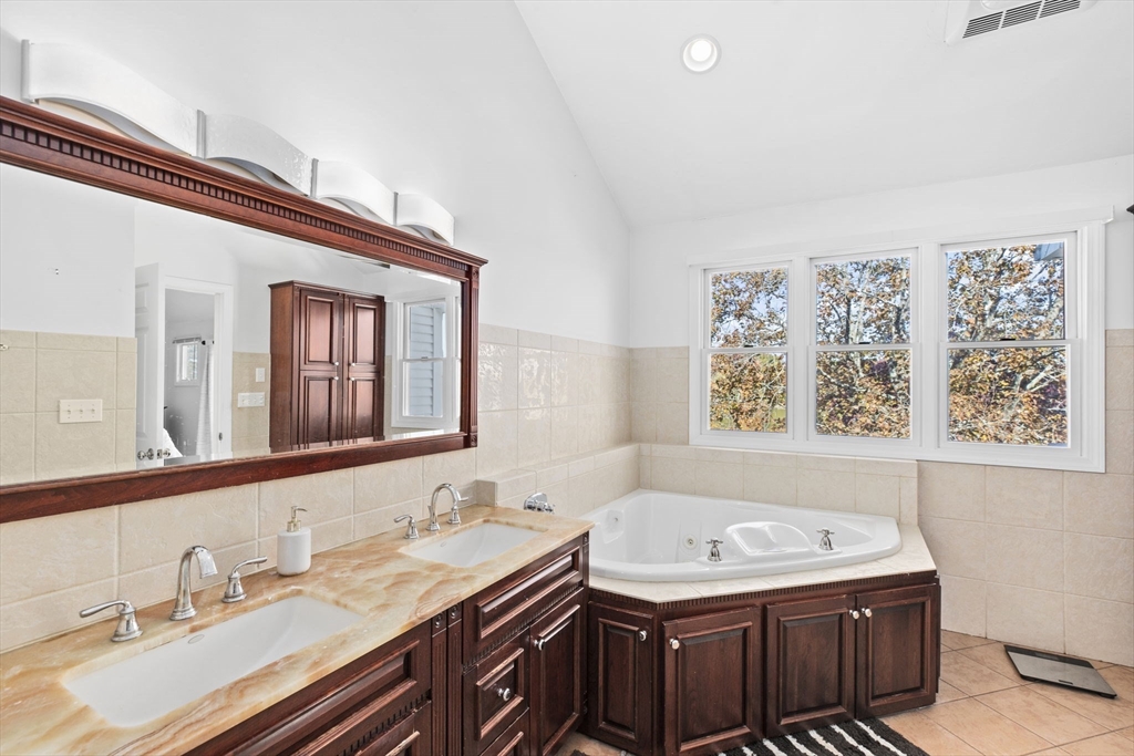 22 Beach Road Sharon, MA 02067 - Photo 15 of 27 a bathroom with a granite countertop sink and a mirror