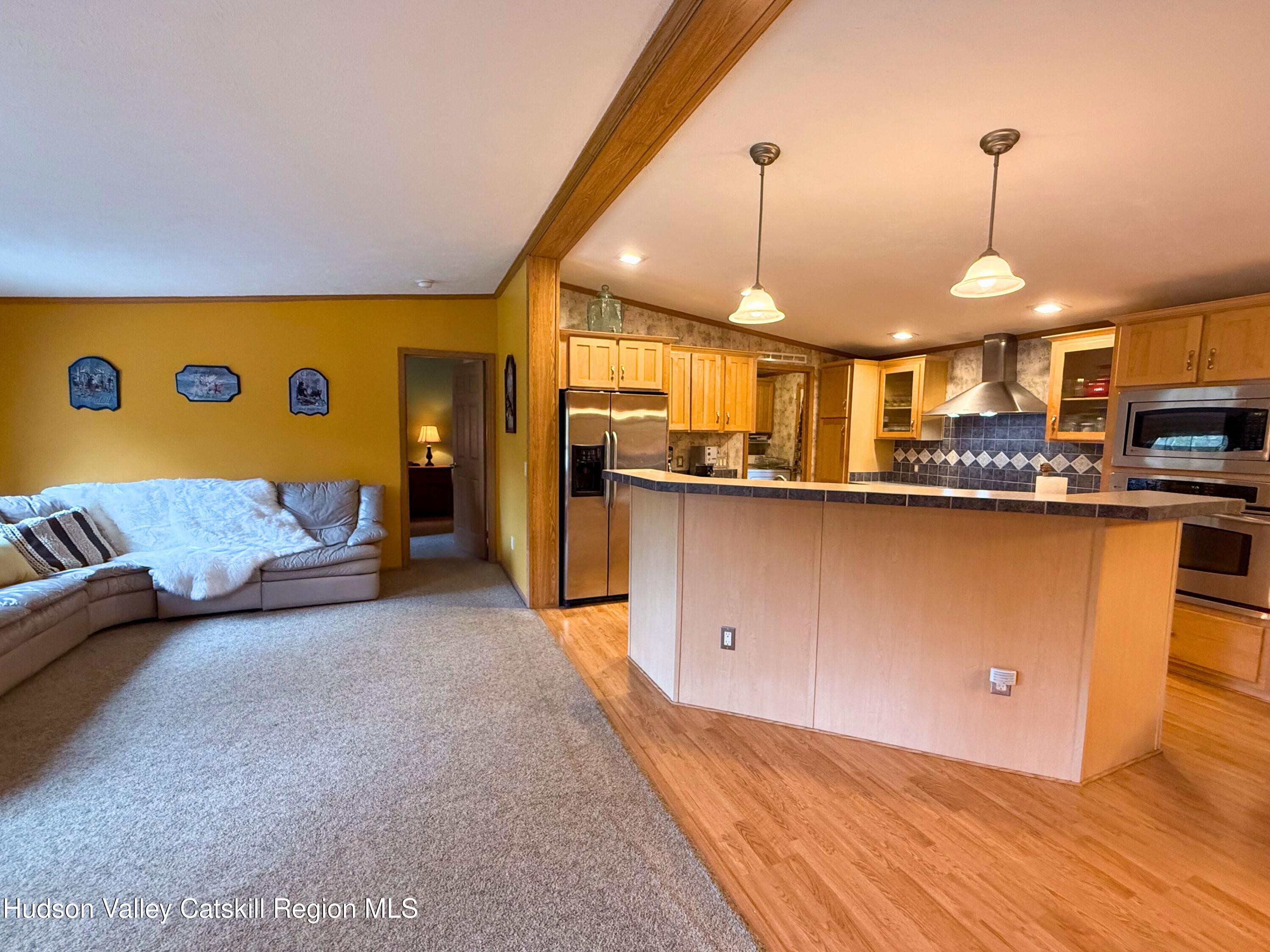 766 Hog Mountain Circle Fleischmanns, NY 12430 - Photo 11 of 31 a kitchen with stainless steel appliances granite countertop a sink a stove and a wooden floors
