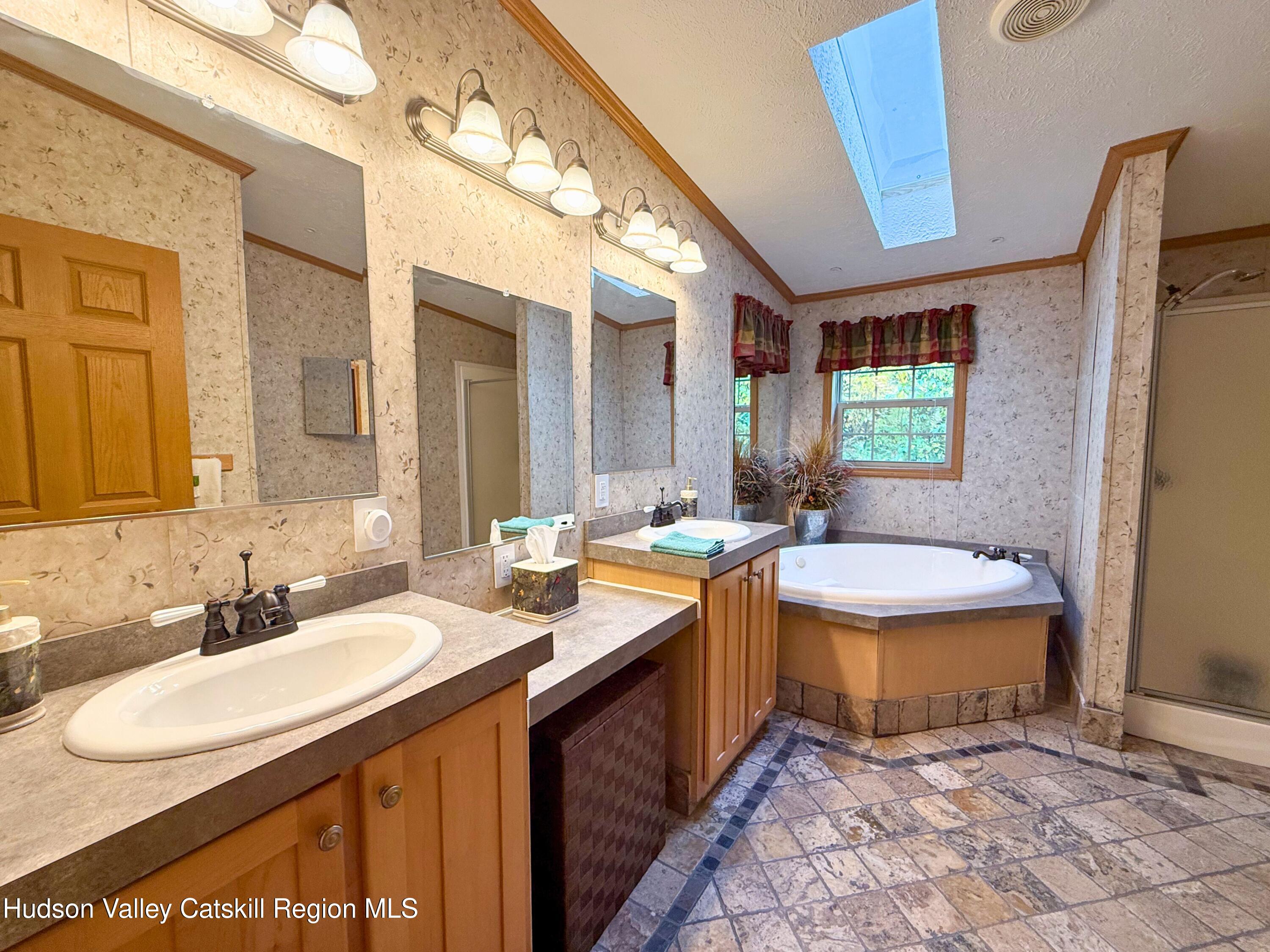 766 Hog Mountain Circle Fleischmanns, NY 12430 - Photo 17 of 31 a bathroom with a sink a toilet a mirror and bathtub