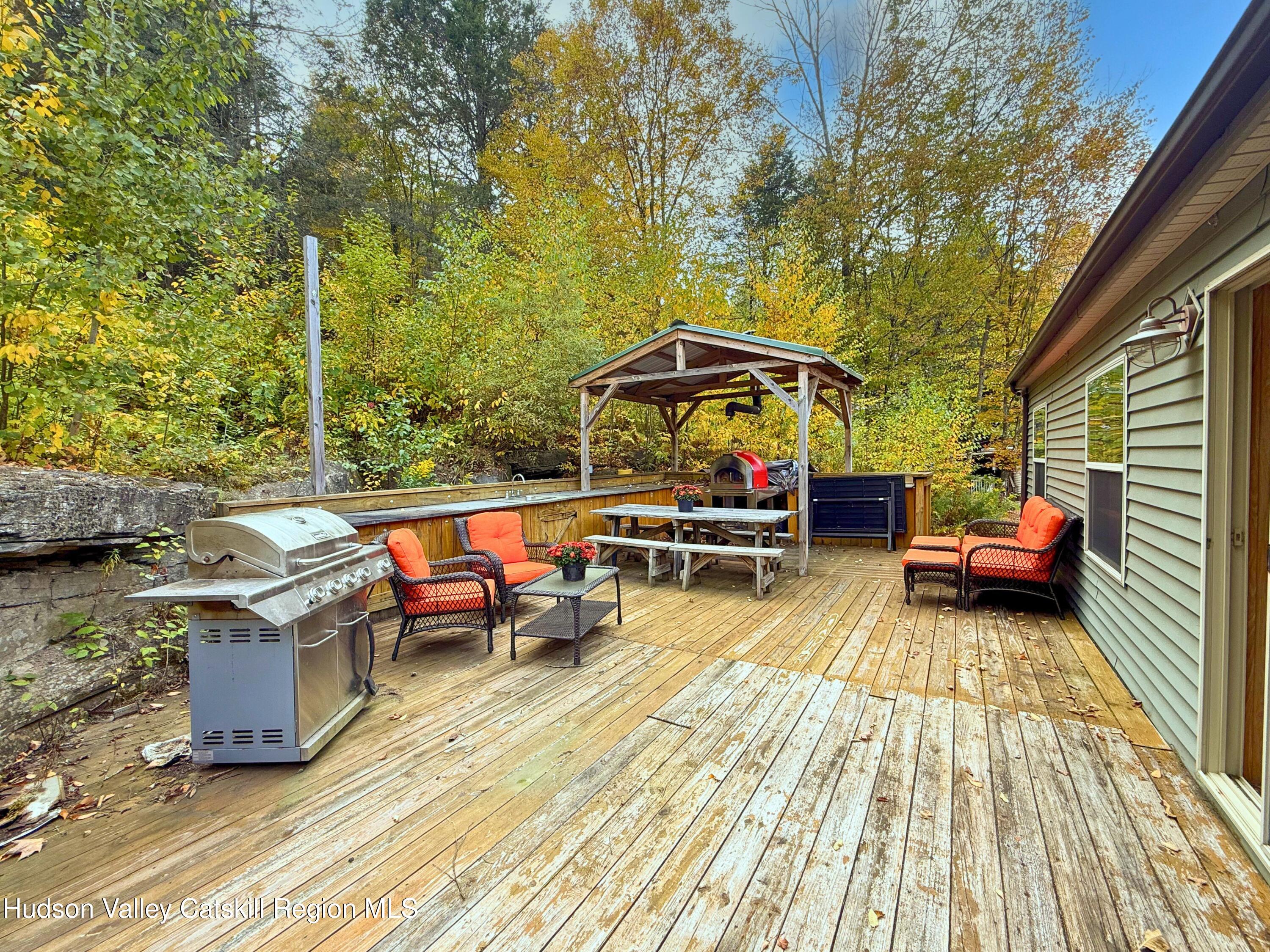 766 Hog Mountain Circle Fleischmanns, NY 12430 - Photo 27 of 31 a view of roof deck with table and chairs a barbeque with wooden floor and fence