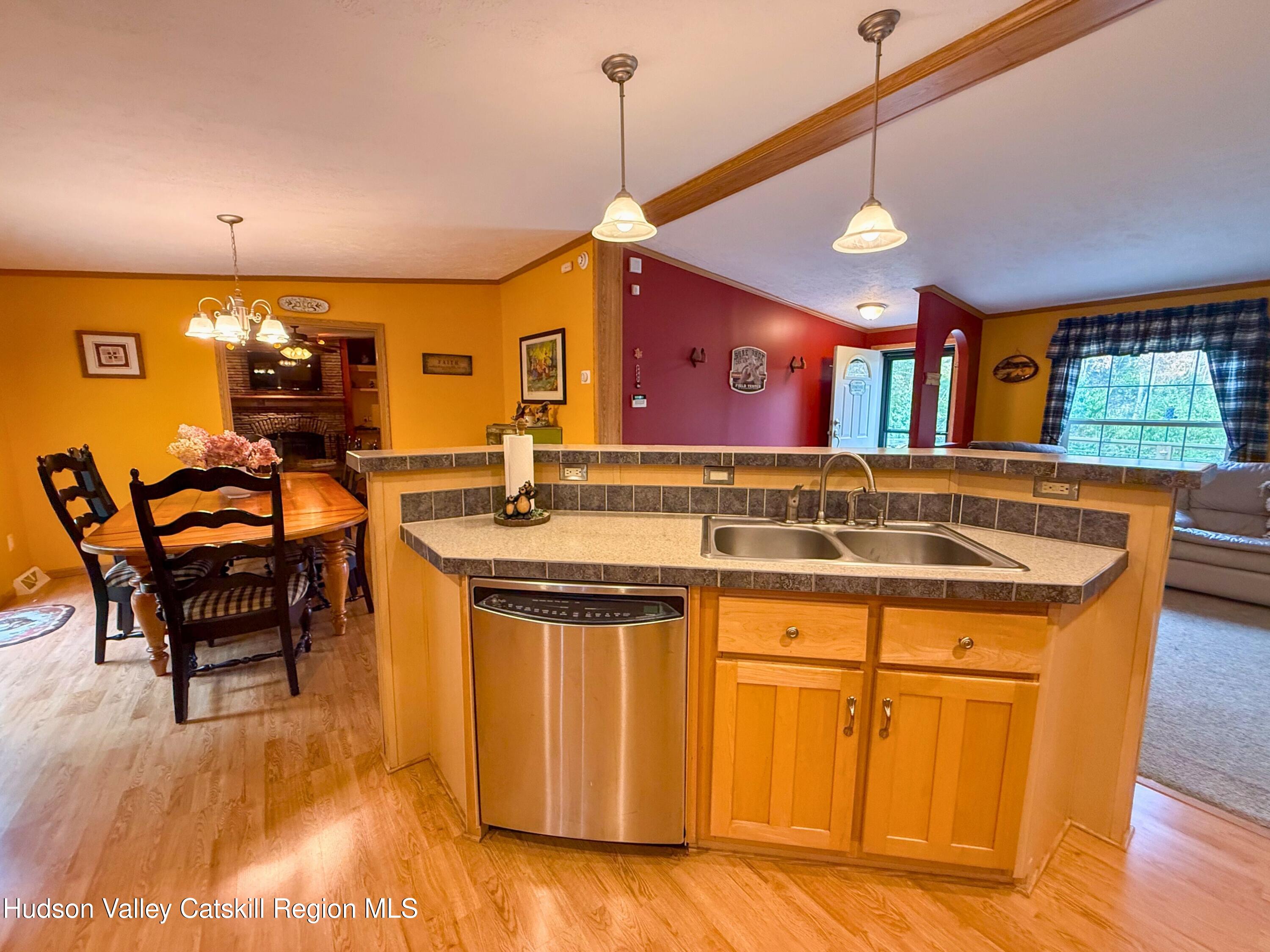 766 Hog Mountain Circle Fleischmanns, NY 12430 - Photo 9 of 31 a view of a kitchen with kitchen island stainless steel appliances wooden floor dining table and chairs