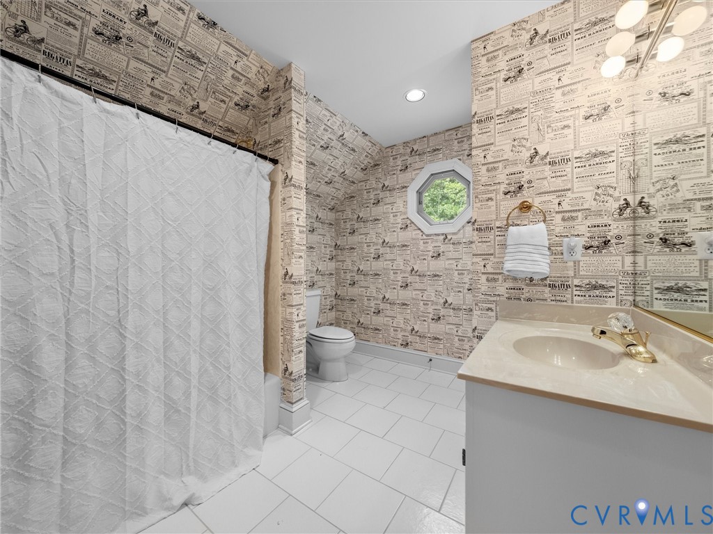 2011 Gamelaw Court Midlothian, VA 23113 - Photo 59 of 77 a bathroom with a sink a toilet and a shower curtain