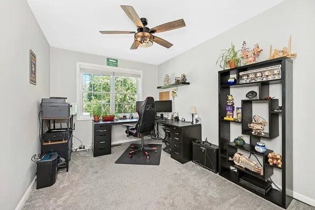 a view of a workspace with furniture and a window