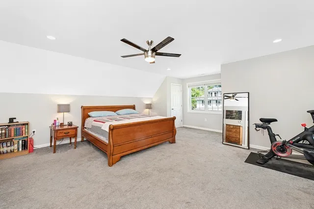 a bedroom with a bed and a ceiling fan