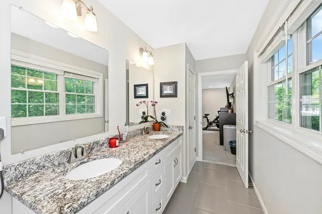a en suite bathroom with a granite countertop tub and a window