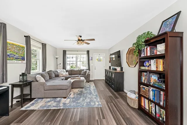 a living room with furniture and a book shelf